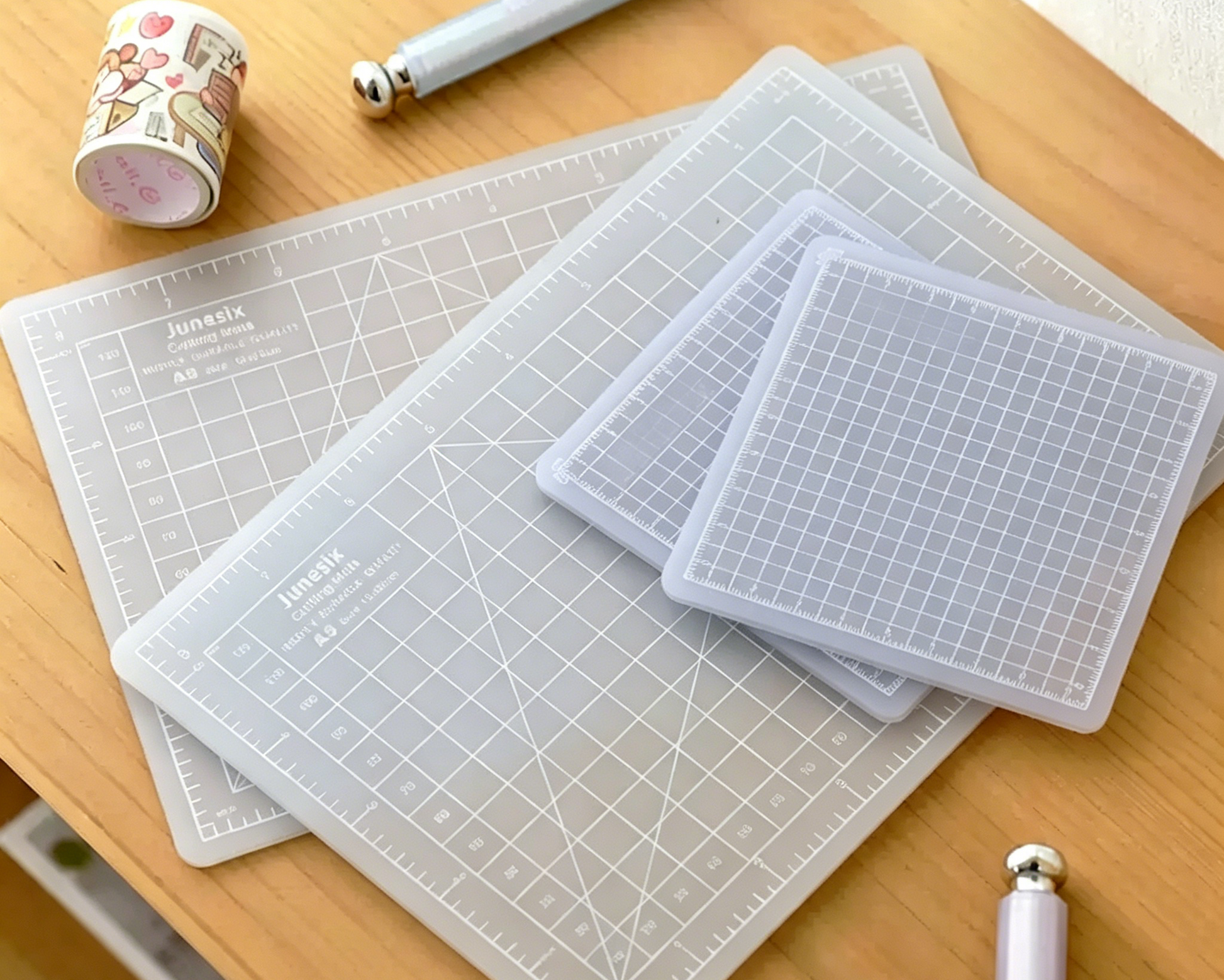 Clear cutting mats with grid lines on a wooden surface