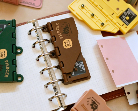 Mini portable 3 hole punch for journals and planners in yellow pink brown and green